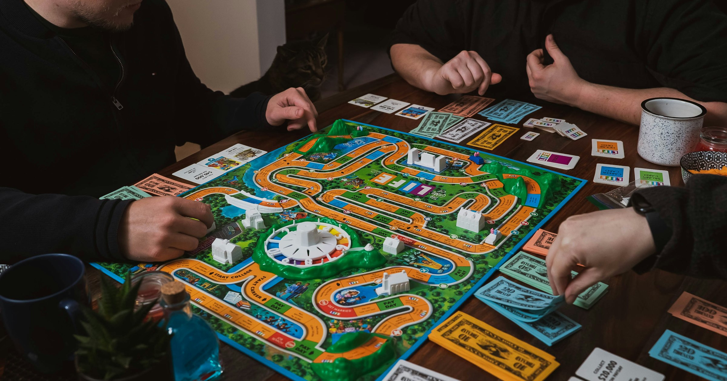 Friends playing a board game around a table