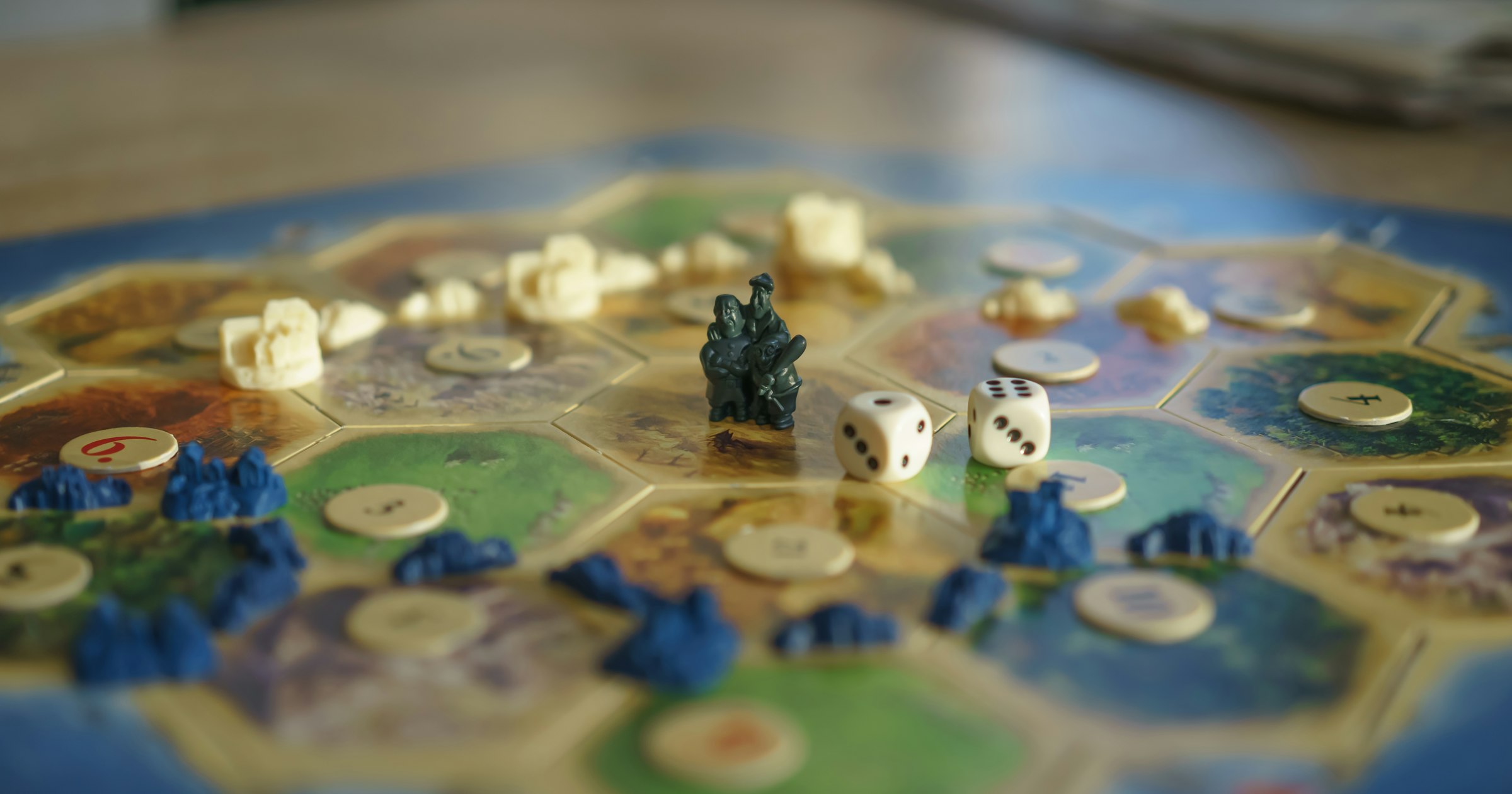Tabletop game pieces and rulebook on a table