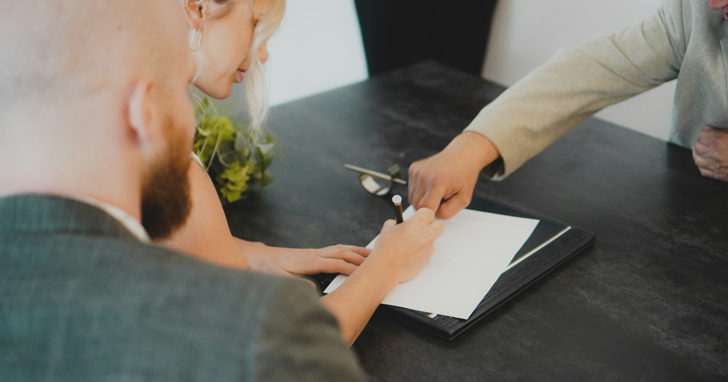 A person reviewing trademark and domain paperwork at a desk