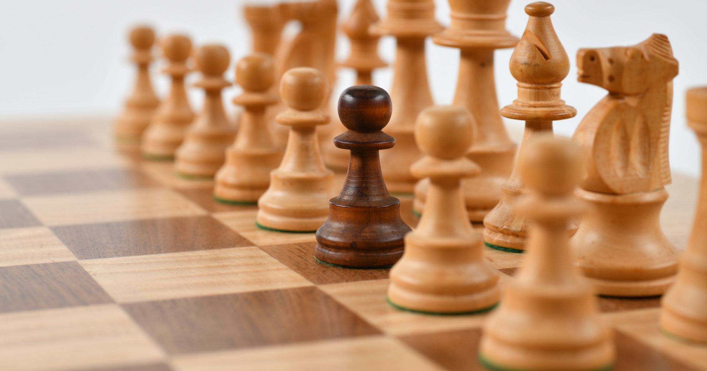 Wooden chess pieces on a chessboard